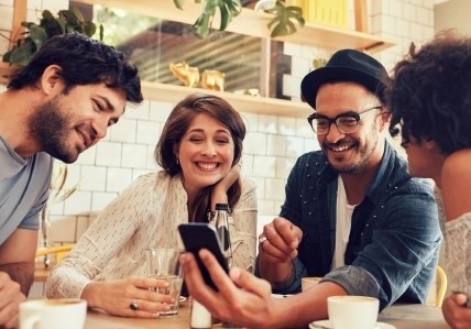 Restaurant Guests Enjoying AI-powered Messaging