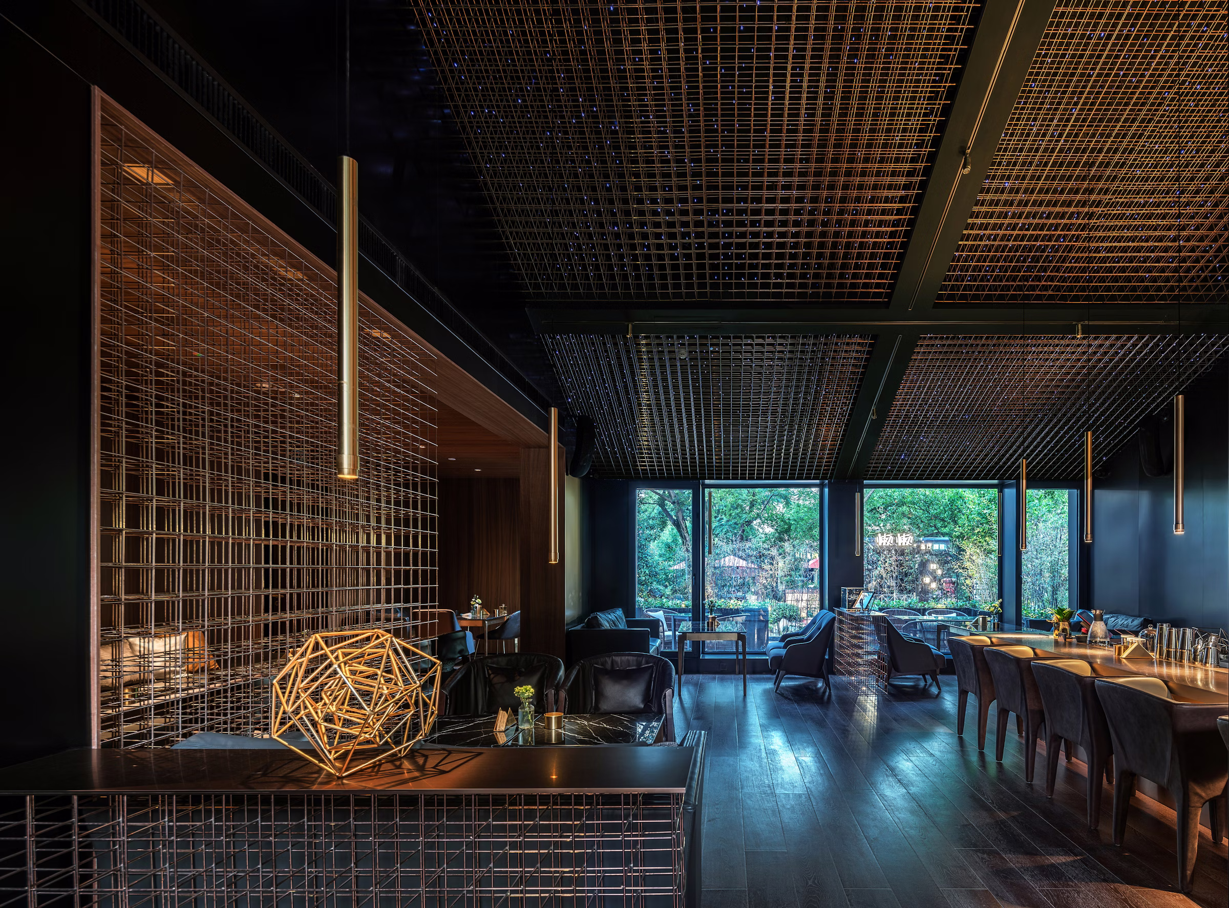 Modern bar interior with polished surfaces and warm overhead lighting